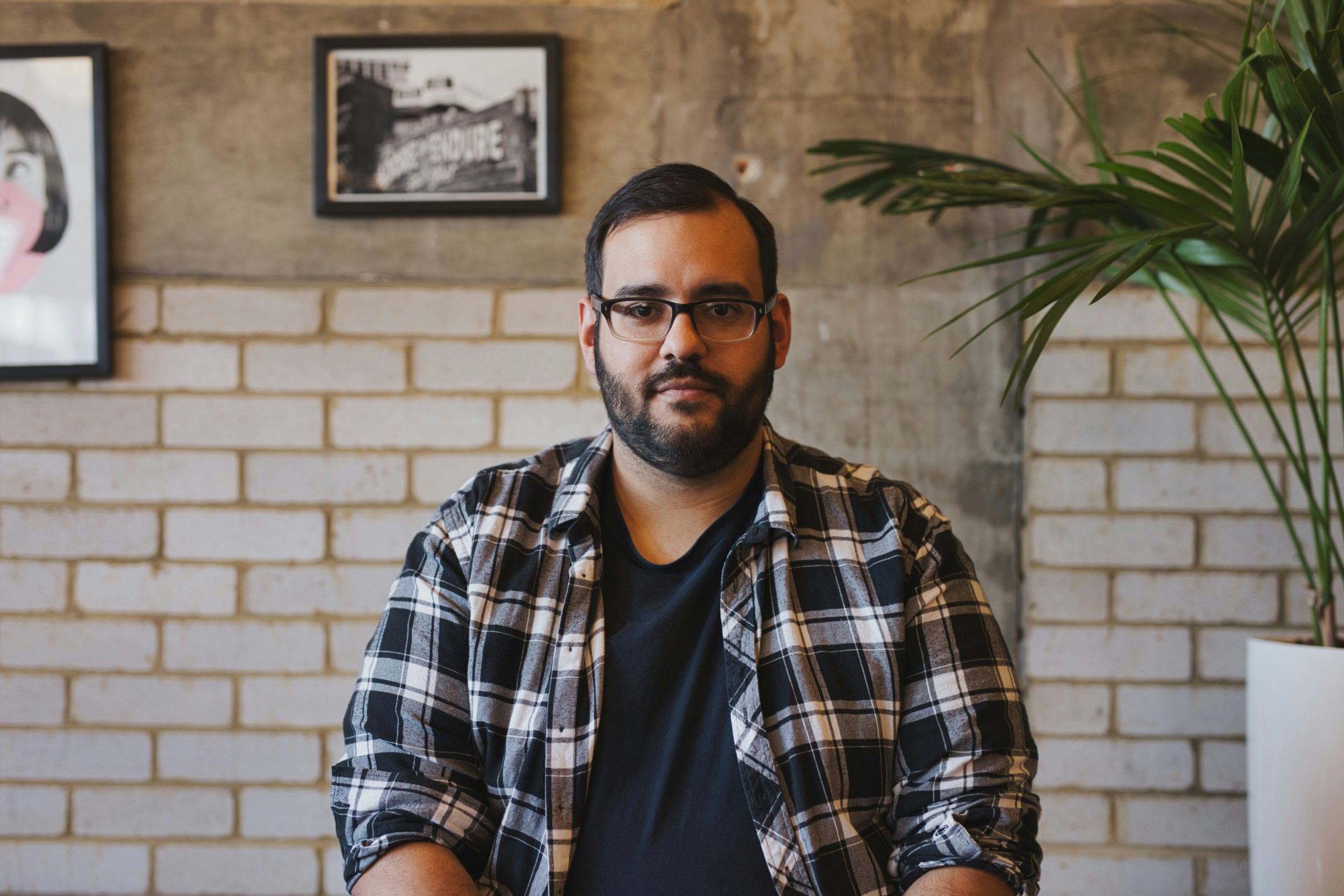 A man sitting in a relaxed pose, symbolizing reflection and personal growth in the context of healing from co-dependency and parentification.