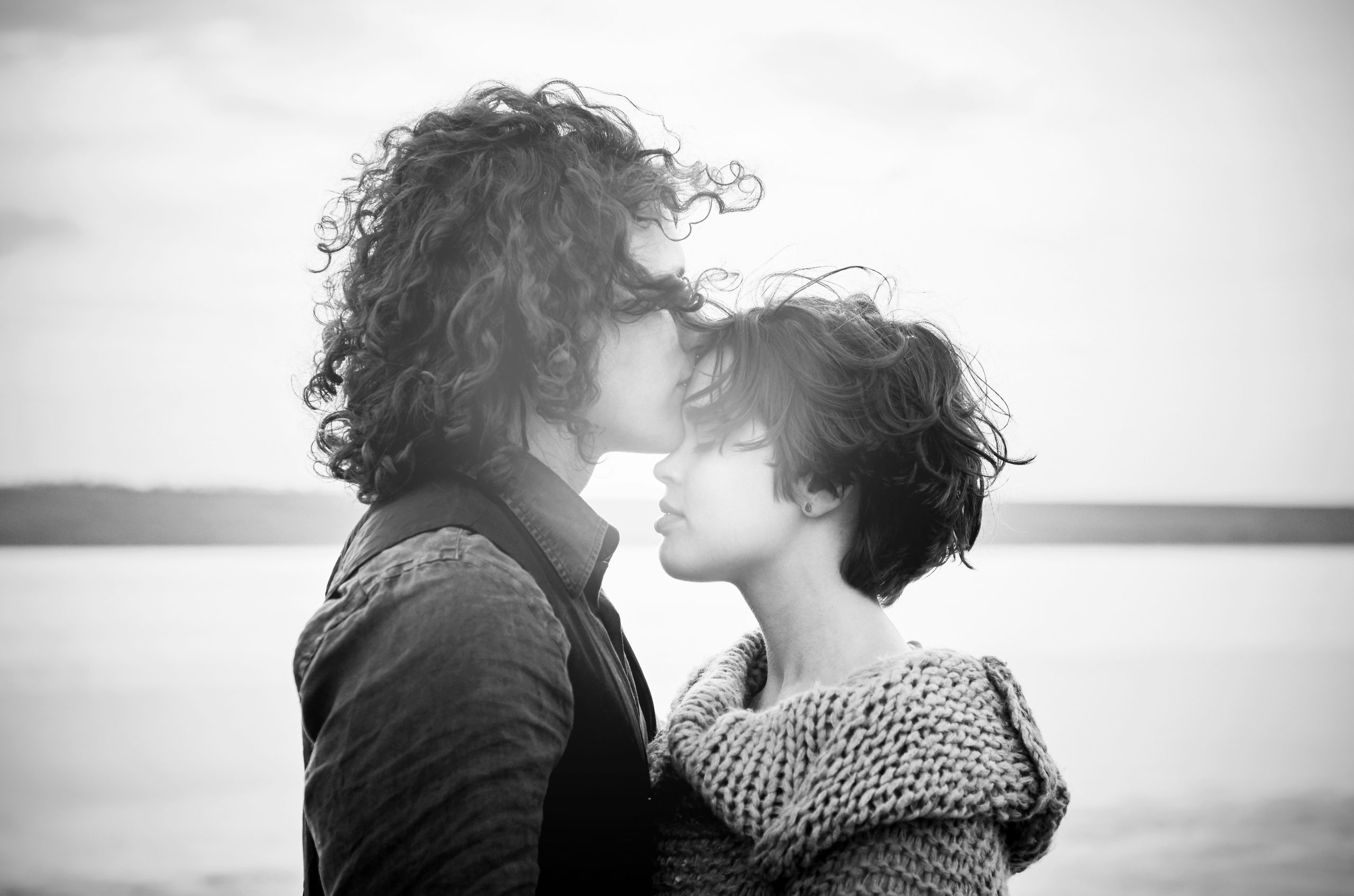 A couple standing closely in black and white, symbolizing relationship dynamics, attachment styles, and emotional connection.